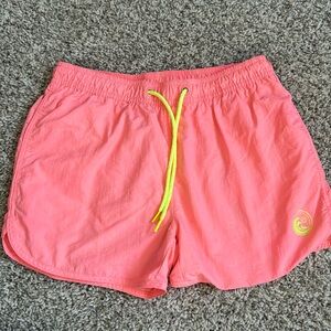 Men’s above the knee swimsuit in bright peach, with yellow accents